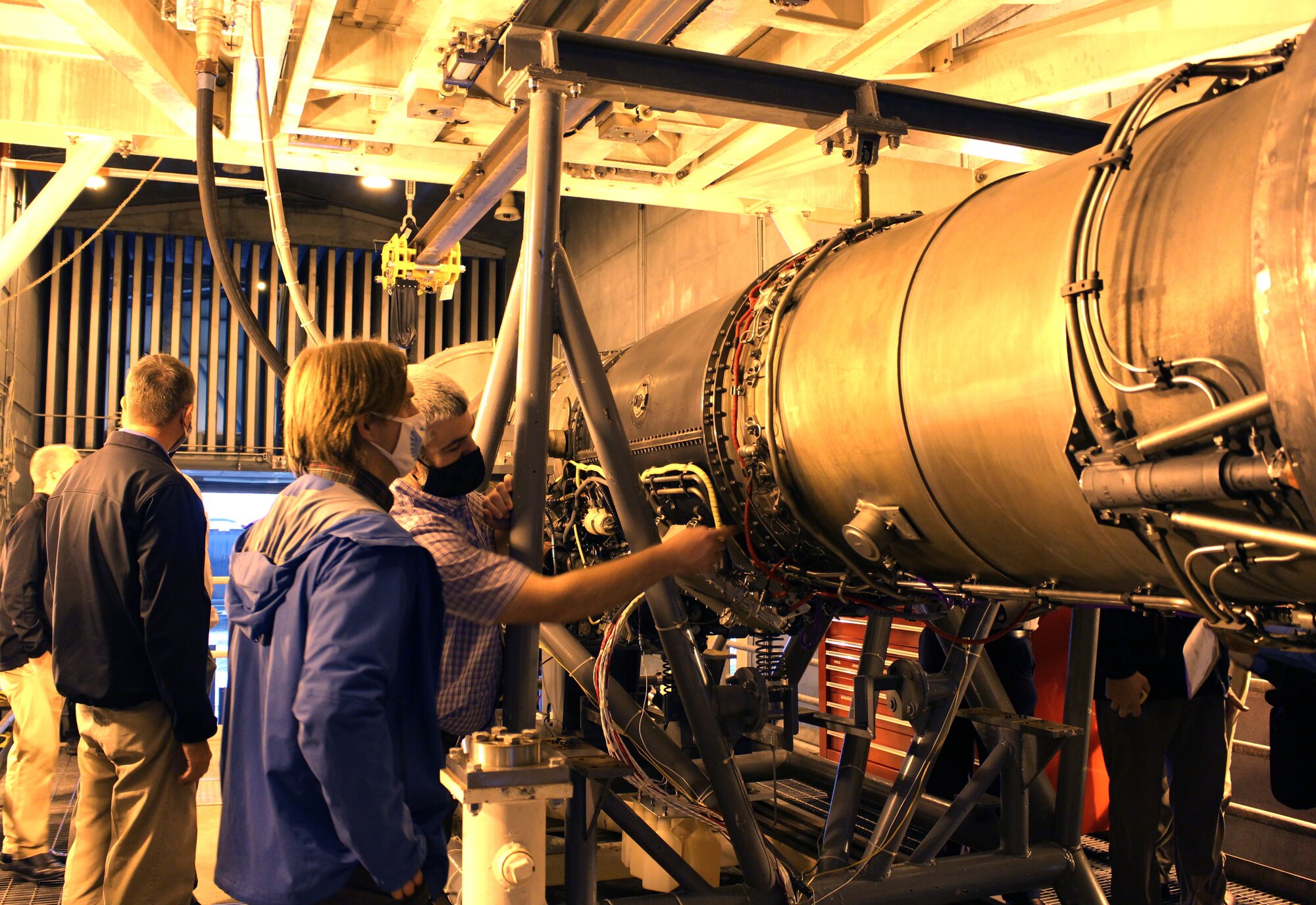 Bernie Williamson, right, the Aeropropulsion technology lead for the Test Systems Branch, speaks to Tom Serbowicz, co-chair of the Propulsion Instrumentation Working Group, Oct. 28, 2020, about how the F404 engine testbed in the Arnold Engineering Development Complex Sea Level 1 engine test cell at Arnold Air Force Base, Tenn., will be used in maturing new turbine engine instrumentation. (U.S. Air Force Photo by Deidre Moon)