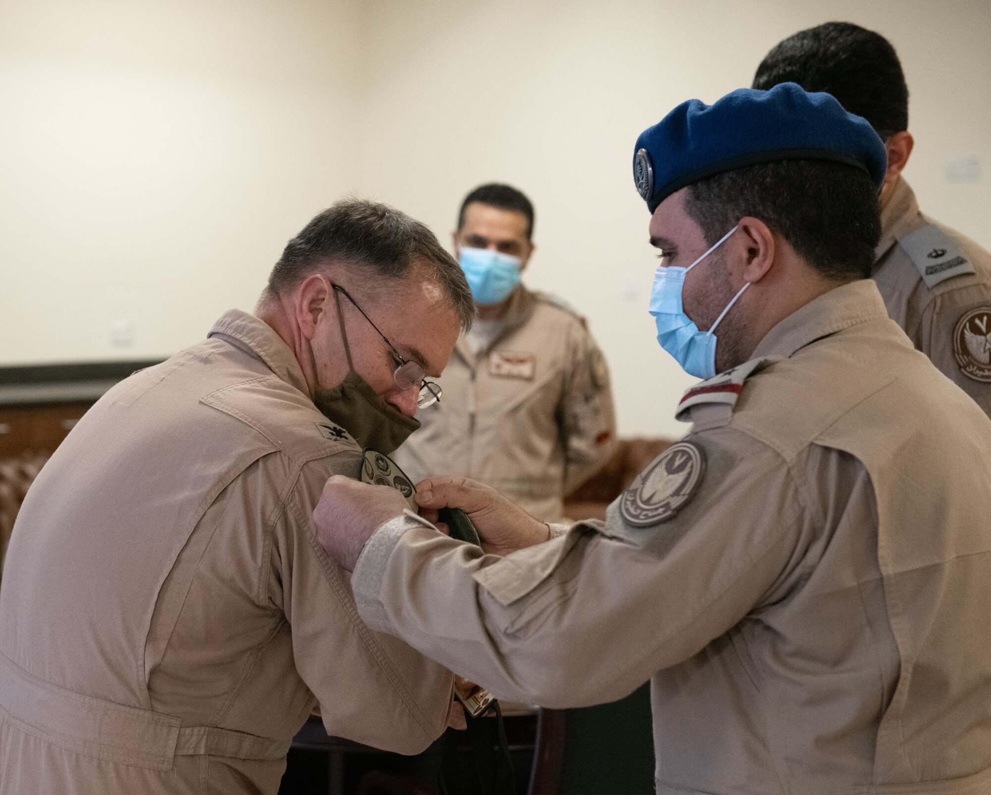 A member of the Royal Saudi Air Force places a patch on Col. Ciero, 378th Air Expeditionary Wing vice commander, Dec. 1, 2020, at King Faisal Air Base, Kingdom of Saudi Arabia.