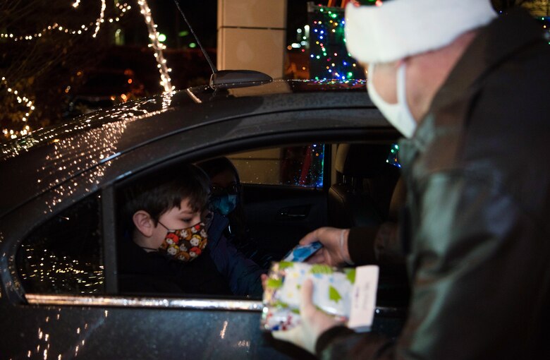The command team passed out gifts along with Mr. and Mrs. Claus as a way to give back to the Spangdahlem community. As shown, the command team wore masks while passing gifts out while urging Sabers to continue to do all they can in reducing the spread of COVID-19