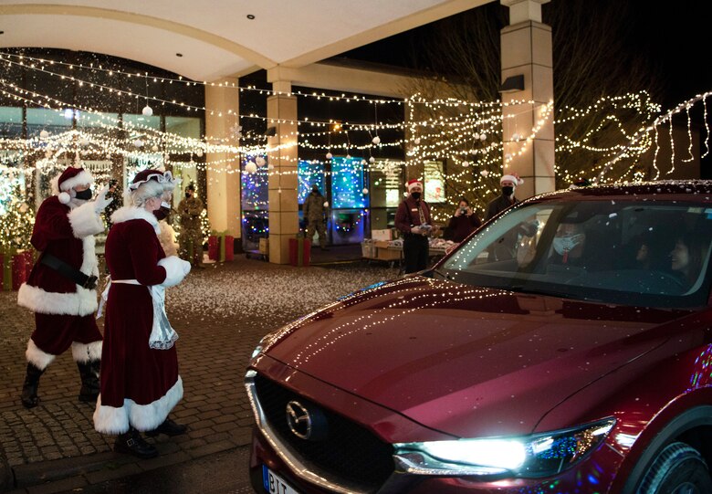 Before passing out gifts, Santa and Mrs. Claus assisted the 52nd Fighter Wing command team in lighting the Christmas tree