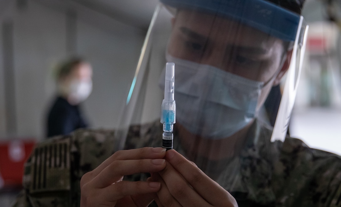 Seaman Jose Acosta prepares an influenza vaccine at Camp Foster, Okinawa, Japan, Nov. 25.