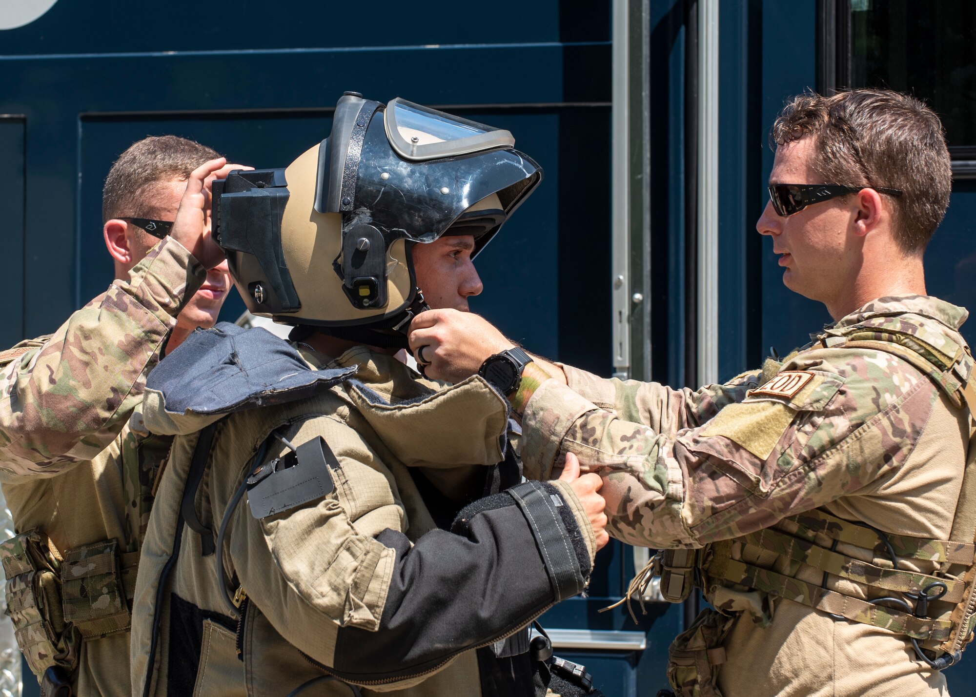 Staff Sgt. Adam Wasson, 4th Civil Engineer Squadron Explosive Ordnance Disposal journeyman (center), puts on a bomb suit with the assistance of Airman First Class Stephen Jesmer (left) and Airman First Class Brian Price (right), 4th CES EOD apprentices, at Seymour Johnson Air Force Base, North Carolina, Aug. 26, 2020.