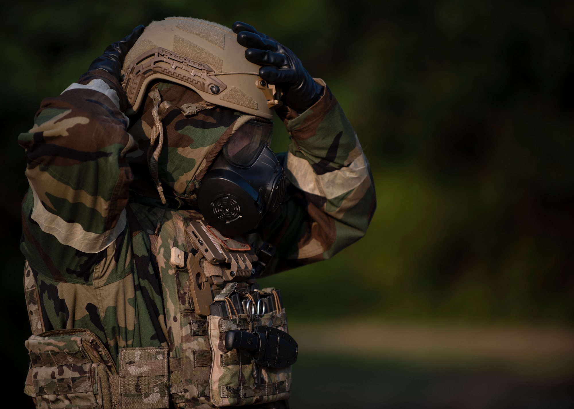 Airman First Class Brian Price, 4th Civil Engineer Squadron Explosive Ordnance Disposal apprentice, adjusts his personal protective equipment before beginning a chemical operation training exercise at Seymour Johnson Air Force Base, North Carolina, August 27, 2020.