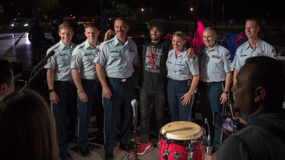 Members of the U.S. Air Force Central Command Band meet and take photos with fans following a performance outside the Marina Mall in Salmiya, Kuwait. The AFCENT Band, based out of Al Udeid Air Base, Qatar, toured countries throughout the Middle East. (U.S. Air Force photo by Tech. Sgt. Daniel Martinez)