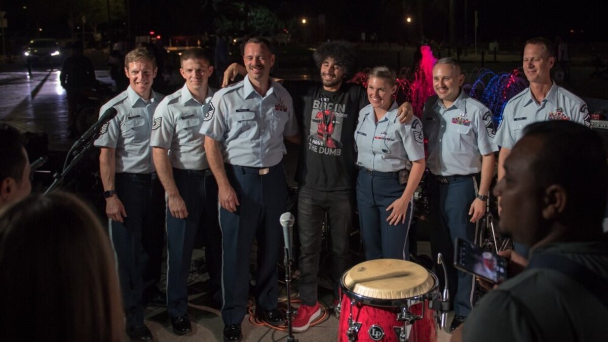 Members of the U.S. Air Force Central Command Band meet and take photos with fans following a performance outside the Marina Mall in Salmiya, Kuwait. The AFCENT Band, based out of Al Udeid Air Base, Qatar, toured countries throughout the Middle East. (U.S. Air Force photo by Tech. Sgt. Daniel Martinez)