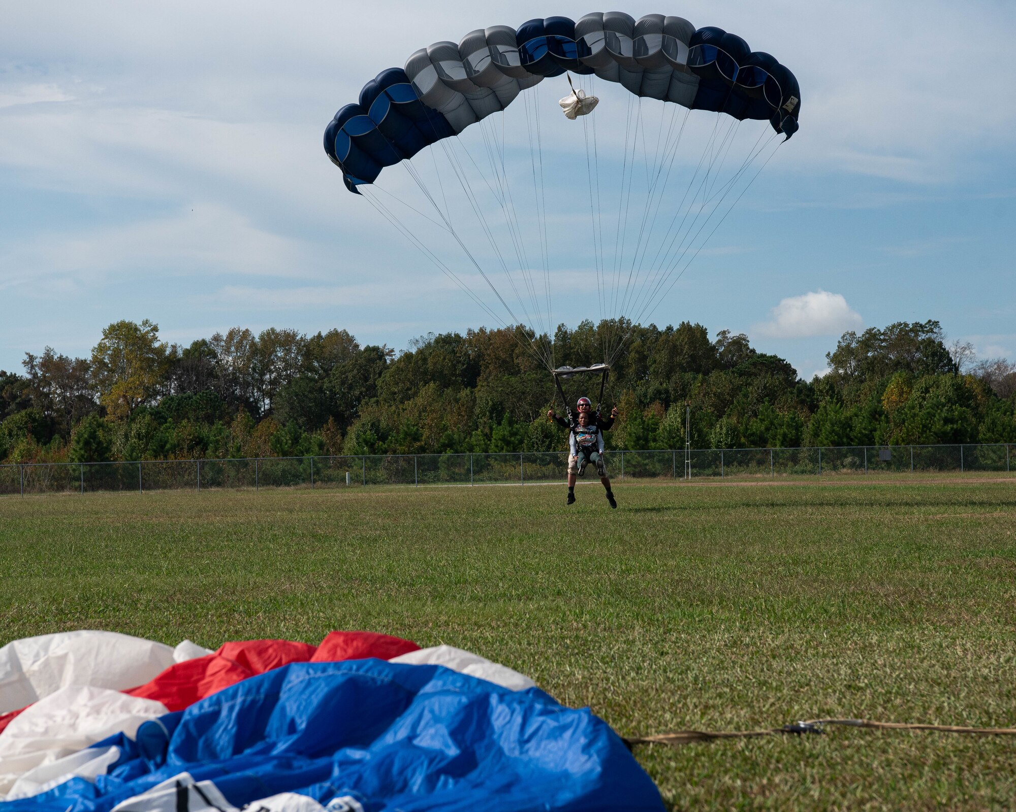 An Airman lands after going skydiving.