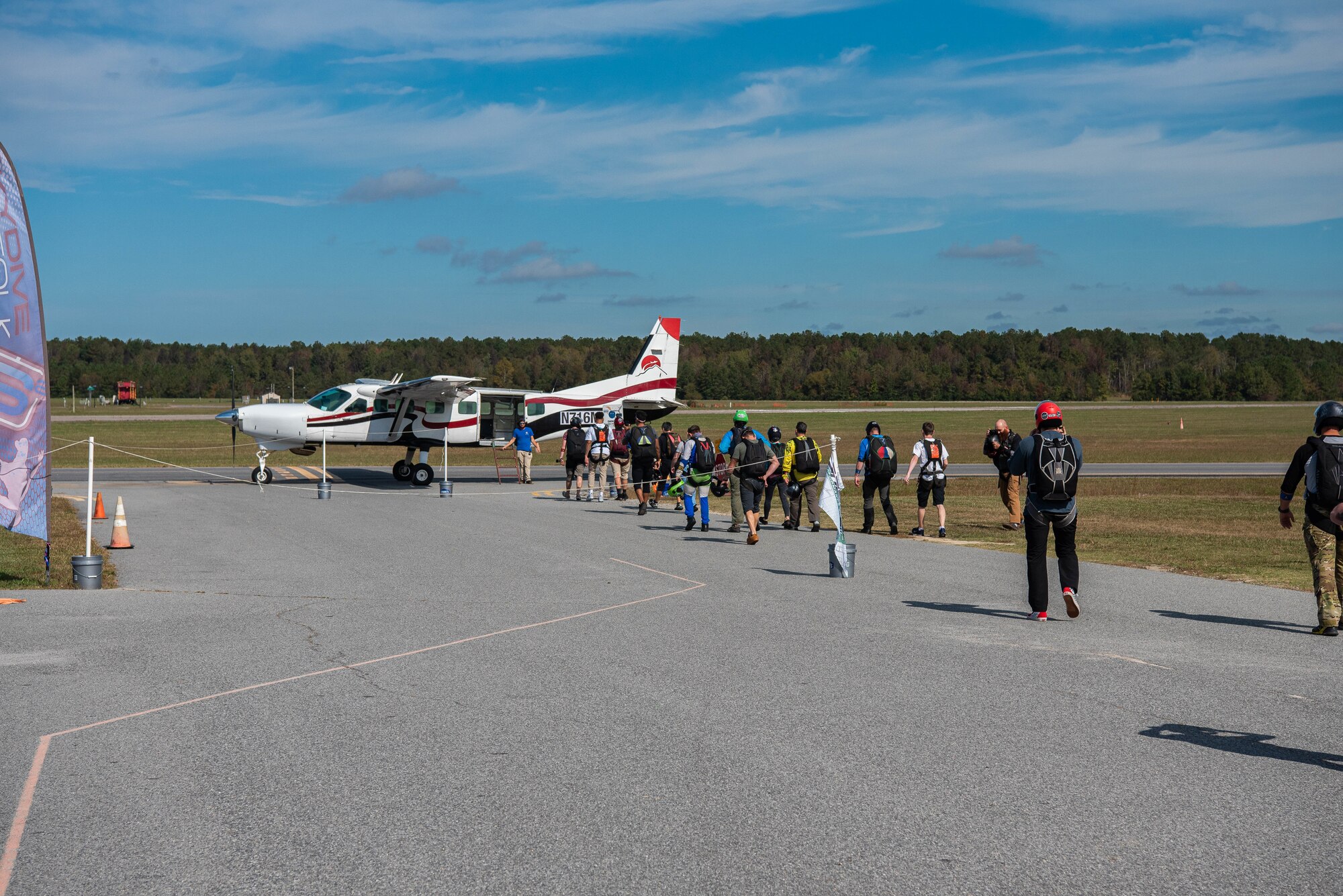 Airmen line up to get on a plane.
