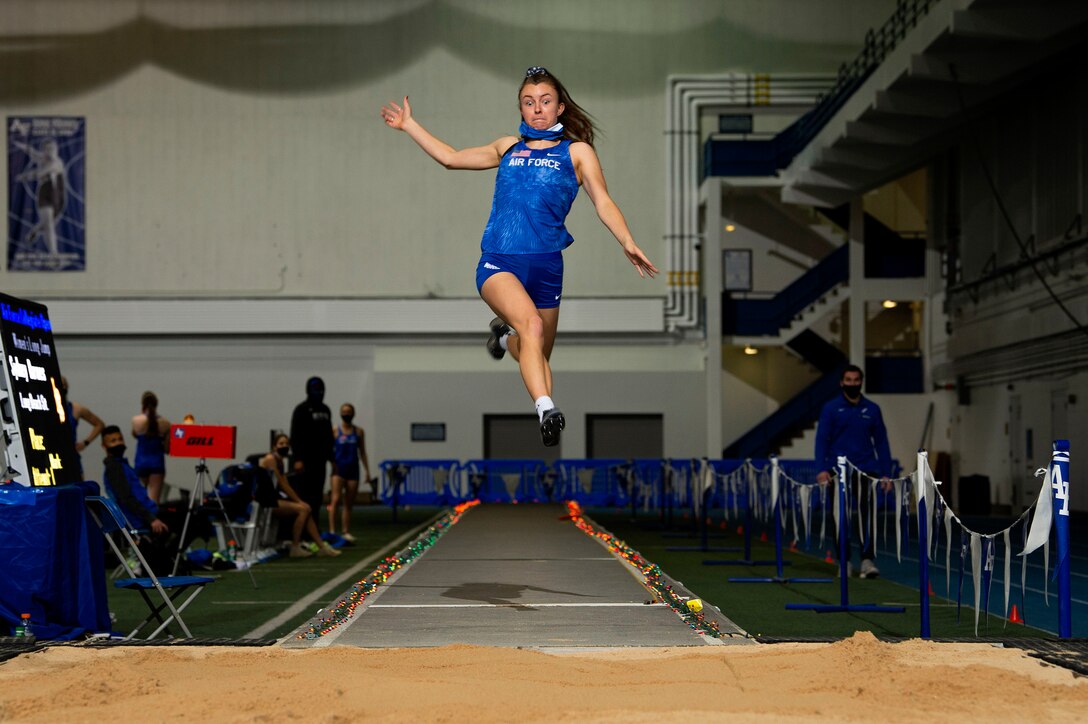 A cadet competes in a high jump.
