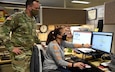 USAMMA’s pharmacy consultant and Distribution Operations Center, or DOC, Director Lt. Col. Todd Reeder receives an update from DOC Deputy Director Liz Andrews on the progress of the COVID-19 ordering system on Dec. 4, as the team receives COVID-19 vaccine orders from throughout the Department of Defense. In anticipation of the U.S. Food and Drug Administration’s emergency use authorization of a vaccine or multiple vaccines, the USAMMA team is collecting COVID-19 vaccine orders from all service branches and submitting them to the U.S. Centers for Disease Control and Prevention