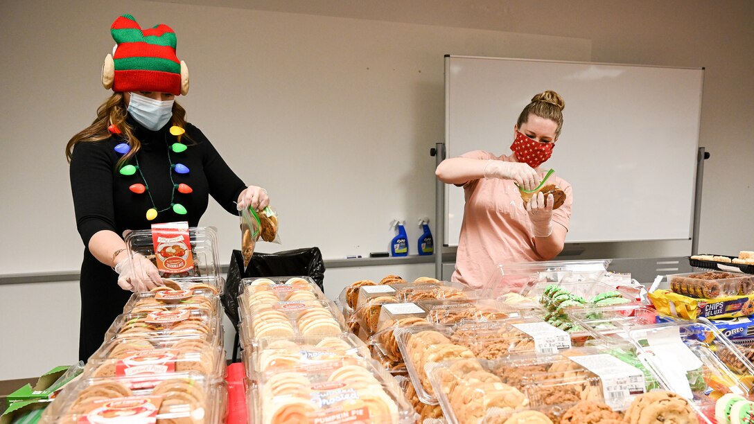Volunteers package cookies.