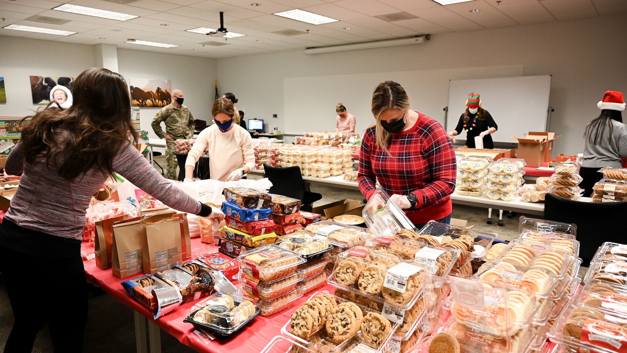 Volunteers package cookies.