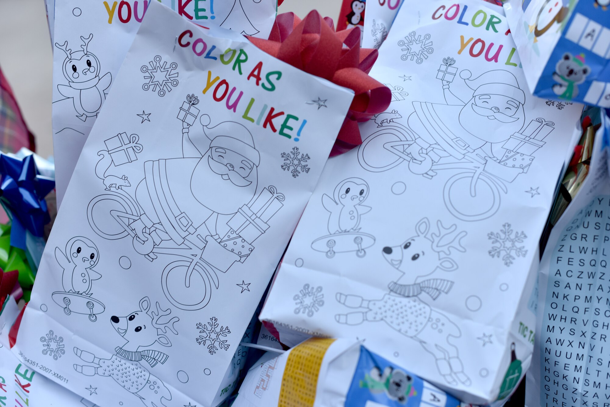 Goody bags are displayed at the drive through pick-up area during the virtual Christmas tree lighting ceremony in front of the Event Center on Goodfellow Air Force Base, Texas, Dec. 4, 2020. Goodfellow members distributed the bags to children who came through the line before the Christmas tree lighting ceremony. (U.S. Air Force photo by Staff Sgt. Seraiah Wolf)