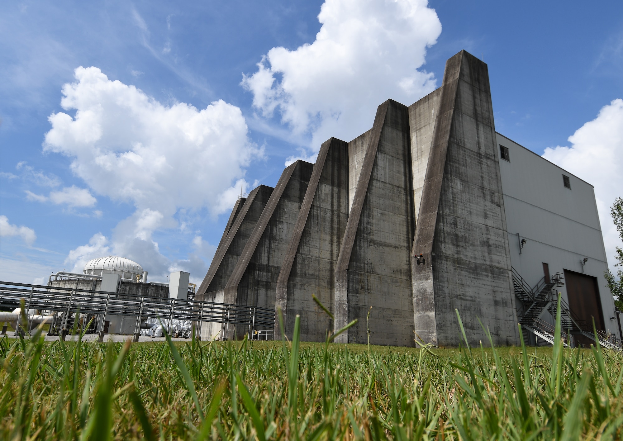 The J-6 Rocket Motor Test Facility has a large blast wall, seen in this image taken July 28, 2020, at Arnold Air Force Base, Tenn., that would deflect debris away from the base in case of an uncontrolled rocket motor explosion. Precautions are taken to minimize the possibility of such an event. (U.S. Air Force photo by Jill Pickett)