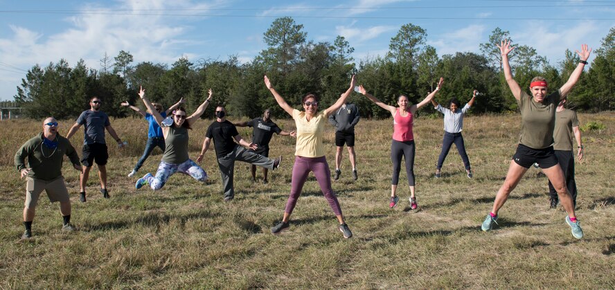 Photo of a group of people posing for a photo outside