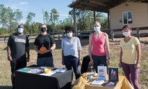 Photo of five people standing next to each other in a line