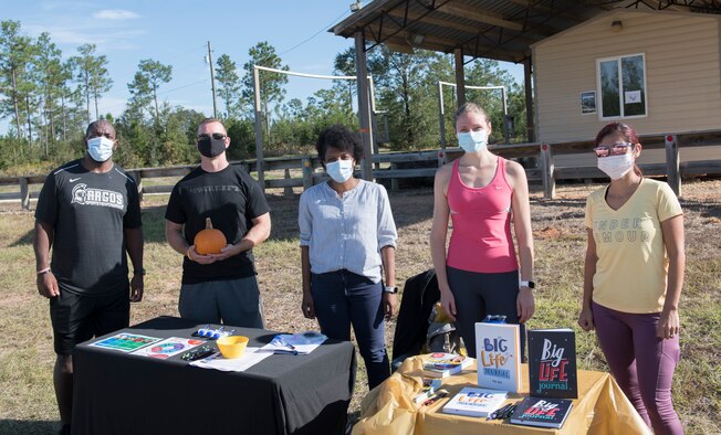 Photo of five people standing next to each other in a line