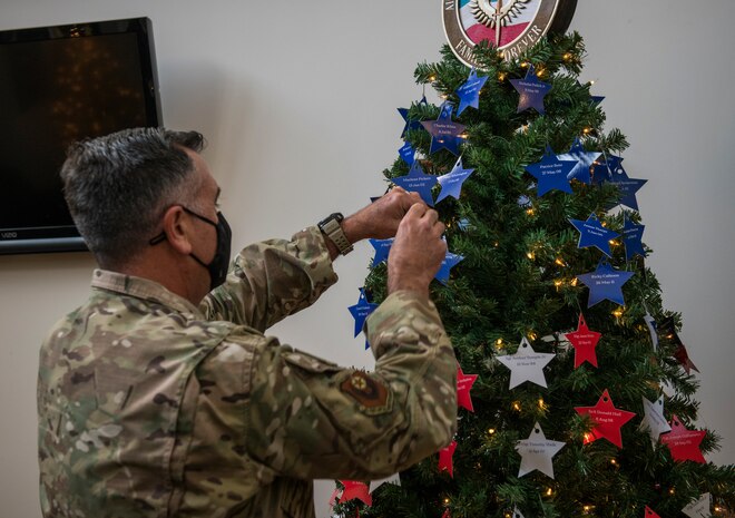 U.S. Air Force Maj. Gen. Eric Hill, deputy commander of Air Force Special Operations Command, places stars on an Honor Tree