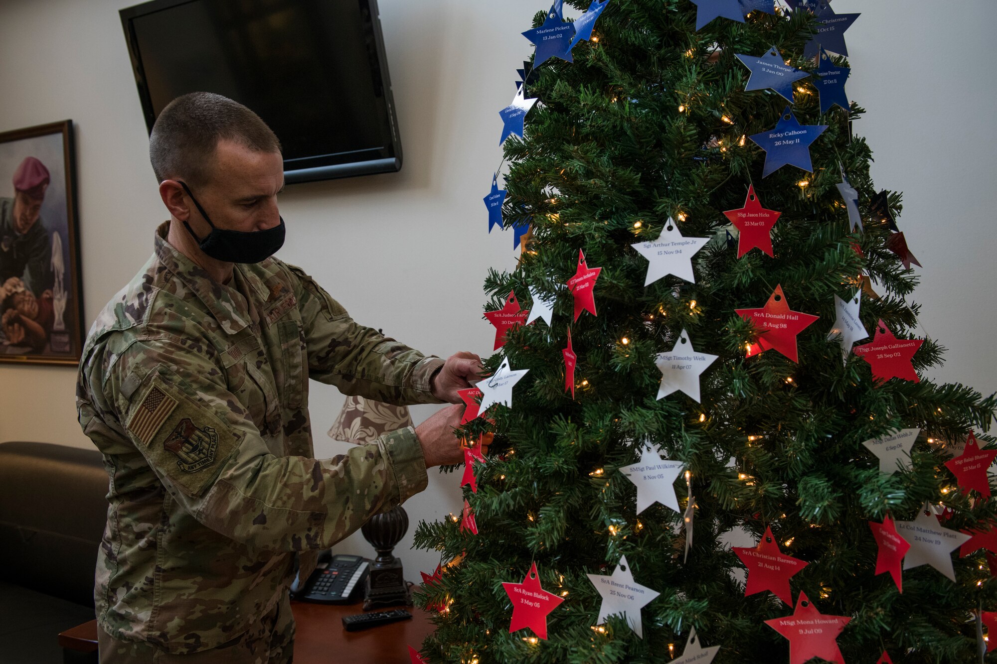 U.S. Air Force Col. Timothy Hood, vice commander of the 1st Special Operations Wing, places stars on an Honor Tree.
