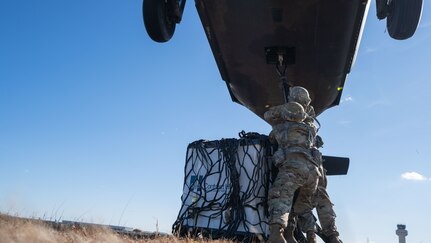 Sgts. Beqa Sabanashvili and Yorby Fenandeztejada, assigned to the 145th Support Maintenance Company, New York Army National Guard, conduct sling-load operations during training at the Army Aviation Safety Facility in Ronkonkoma, N.Y., on Nov. 24, 2020. Sling-load operations allow for the quick deployment of supplies during combat or to areas that are geographically difficult to reach during natural disasters or emergencies.