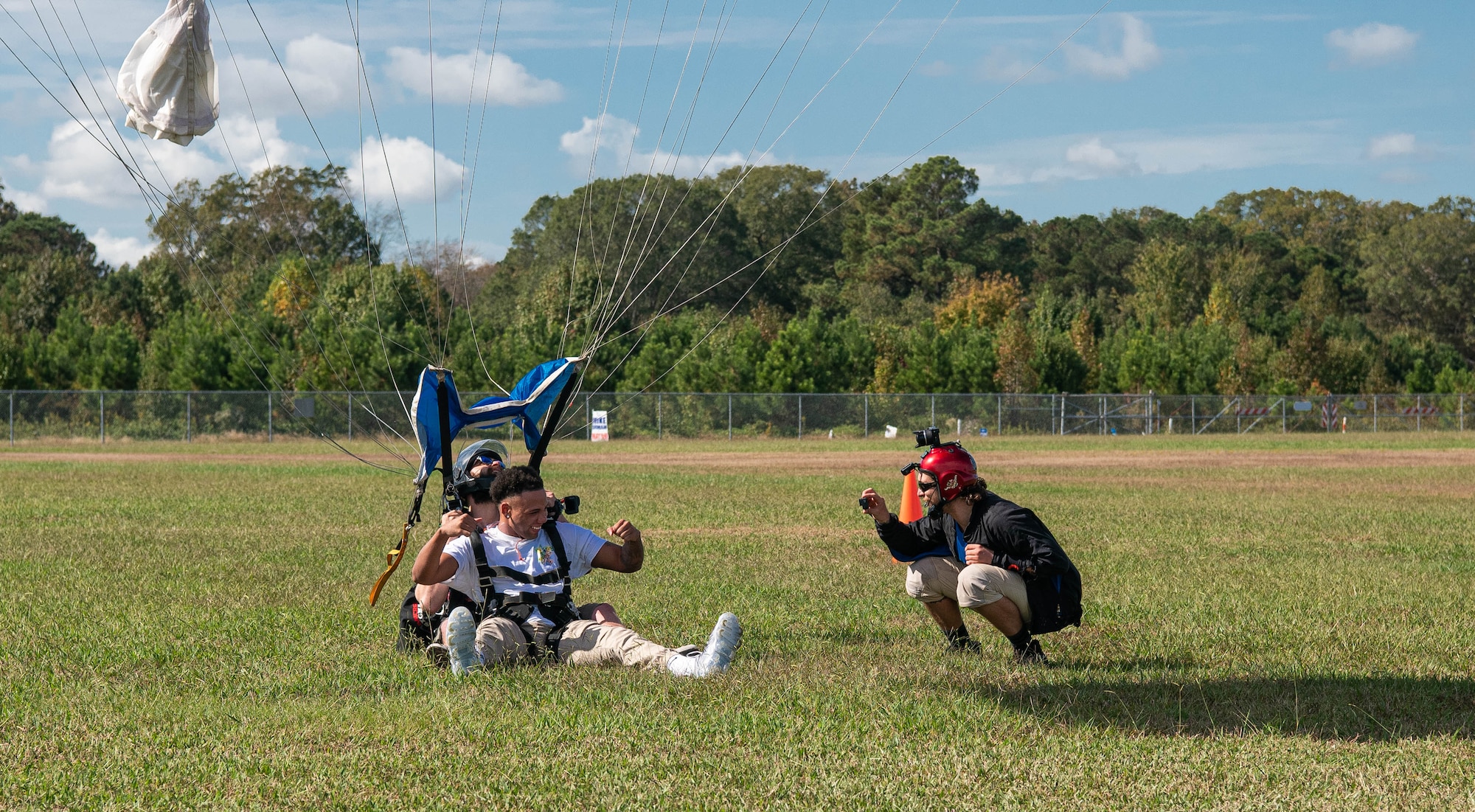 An Airman lands after going skydiving.