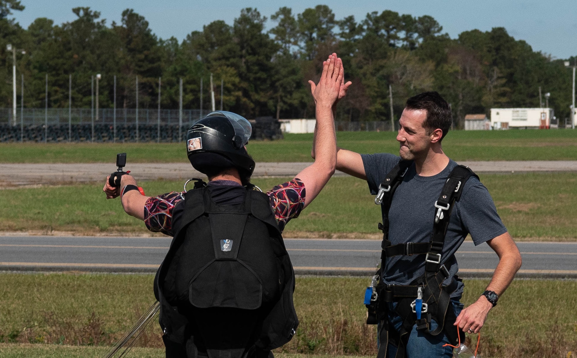 An Airman high-fives his instructor after landing.