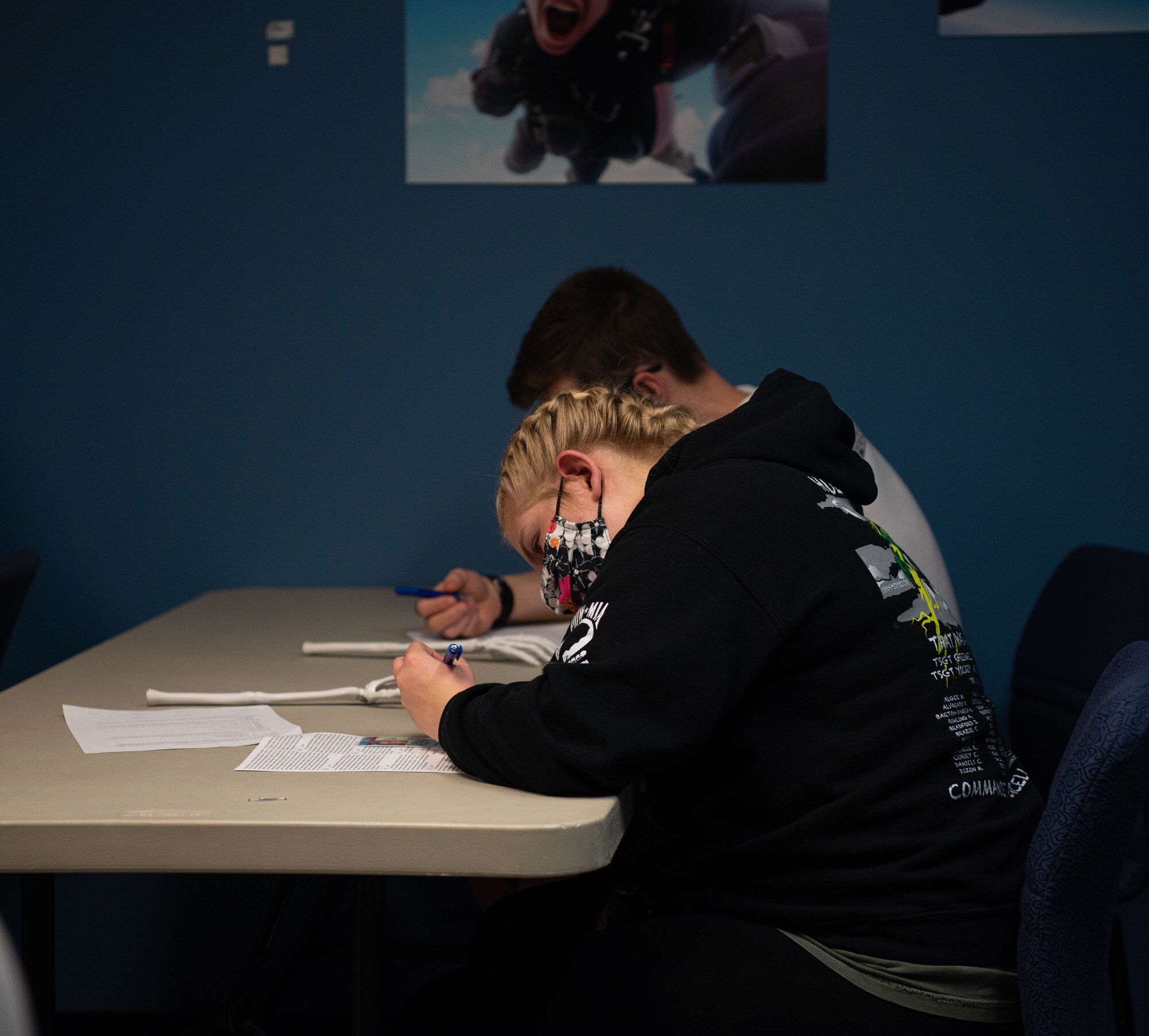 An Airman fills out paperwork before going skydiving.