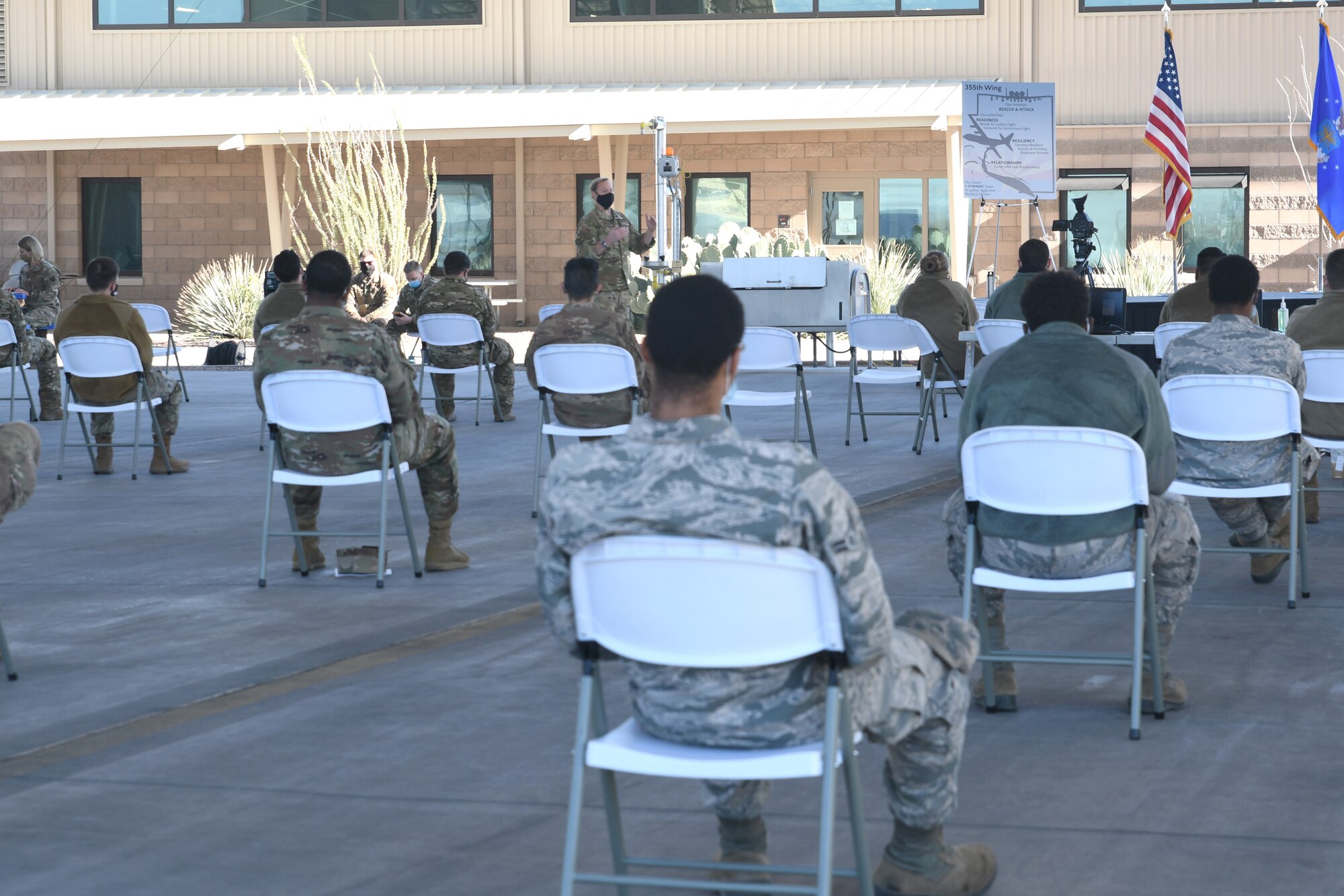 A picture of Airmen sitting at an all call.