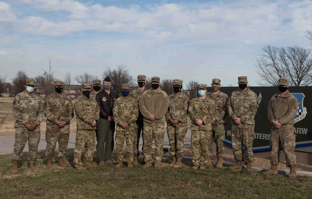 Senior Leadership poses for a photo with McConnell's two chief master sergeant selects Dec. 1, 2020, at McConnell Air Force Base, Kansas. Air Force officials selected 518 senior master sergeants for promotion to chief master sergeants during the 20E9 promotion cycle. (U.S. Air Force photo by Senior Airman Alan Ricker)