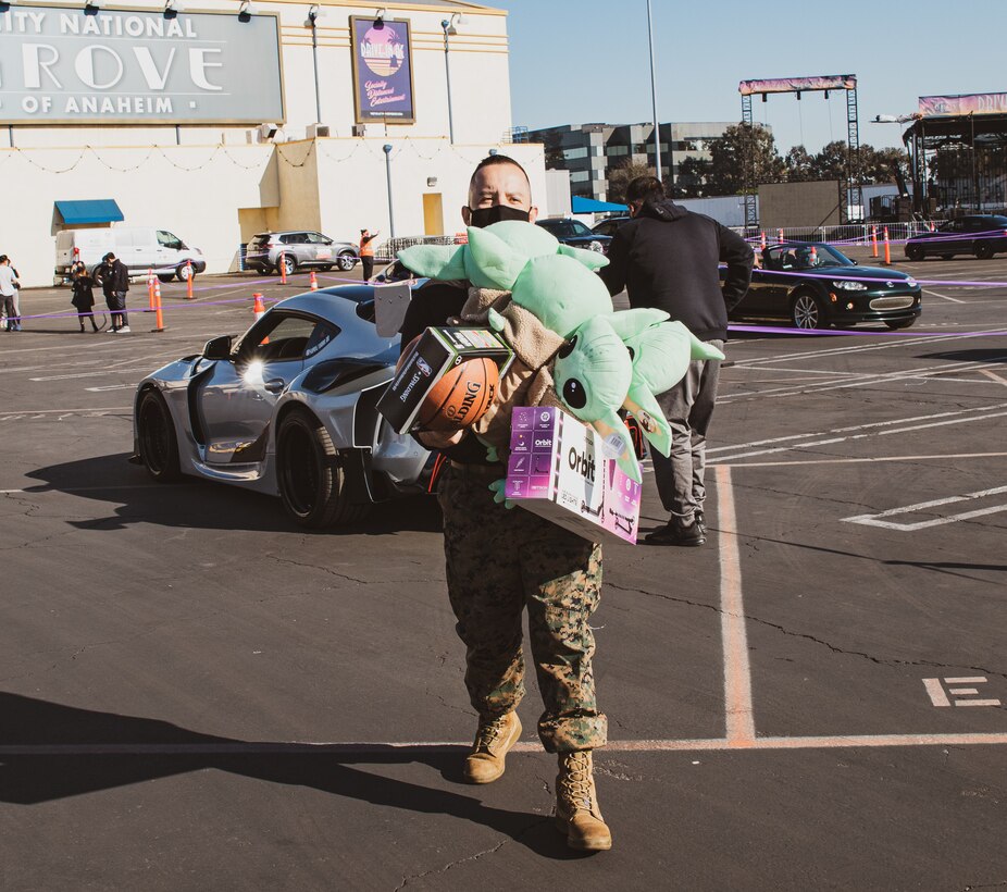U.S. Marine Corps Staff Sgt. Ruben Lopez, a recruiter with Marine Corps Recruiting Sub-Station Orange, assists in collecting toys for the Winter Toy Drive 2020 in Anaheim, California on Dec. 6, 2020. Marines with Recruiting Station Orange County volunteered to assist California Love Drop and Purist with their annual toy drive to help local kids in need. (U.S. Marine Corps photo by Sgt. Sarah Ralph)
