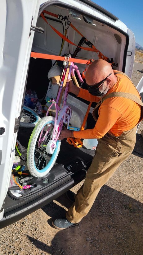 Santa's elf, John Venable, 926th Wing Key Spouse, is working hard to build bicycles for the 926th Wing Airman and Family Readiness Operation Holiday Hope event, Dec. 3, 2020 at Nellis Air Force Base, Nev. (U.S. Air Force photo by Staff Sgt. Paige Yenke)