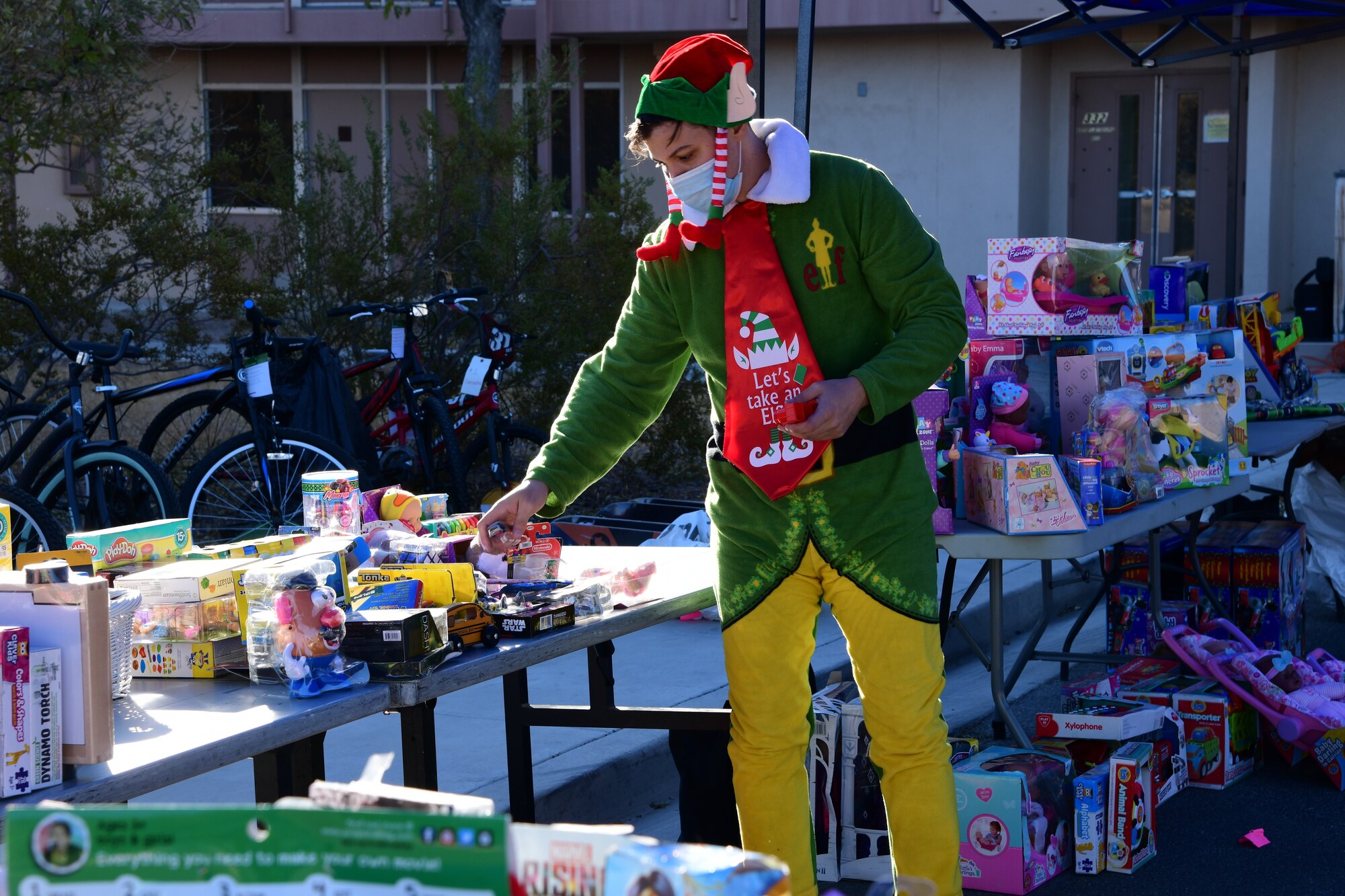 Santa's elf, Tech. Sgt. Charles Shaw, 926th Wing volunteer, is getting into the spirit while organizing and displaying everything to prepare for the 926th Wing Airman and Family Readiness Operation Holiday Hope event, Dec. 5, 2020 at Nellis Air Force Base, Nev. (U.S. Air Force photo by Staff Sgt. Paige Yenke)