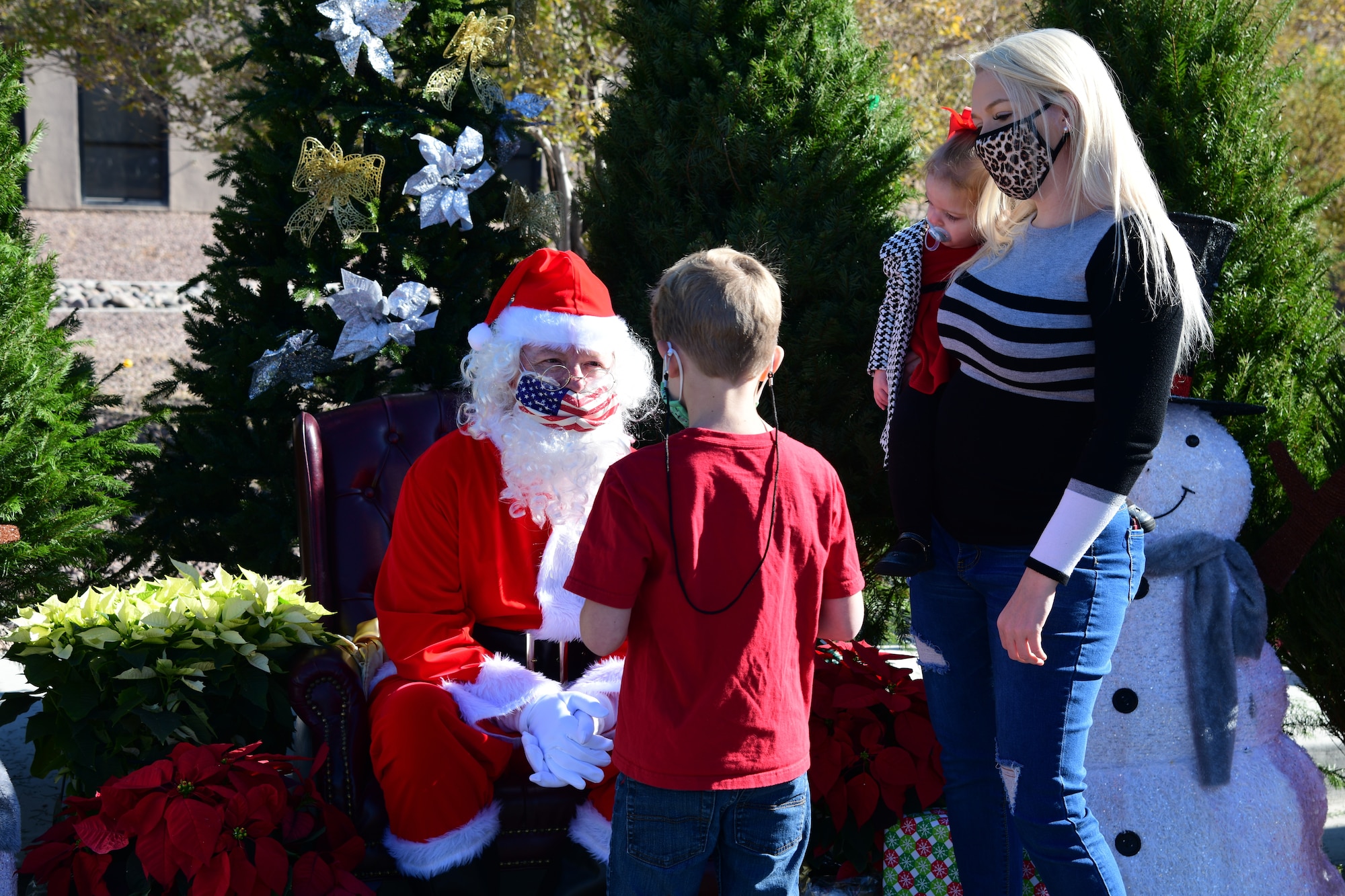 Santa greets families, takes photos and hands out candy canes to the kids during the Airman and Family Readiness Operation Holiday Hope event, Dec. 5, 2020, Nellis Air Force Base, Nev. (U.S. Air Force Photo by Staff Sgt. Paige Yenke)