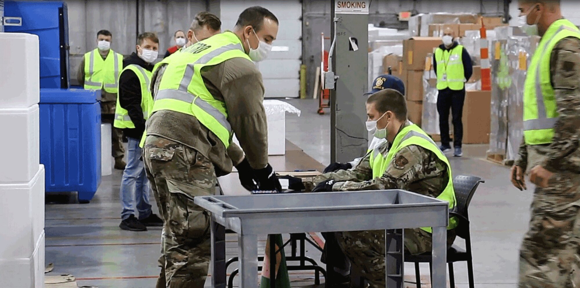 Military and civilian partners form an assembly line around tables and practice safely transferring glass vials into small boxes. About two dozen Guard members have been working with the Ohio Department of Health to develop the logistics plan to receive and repackage the COVID-19 vaccine for distribution.