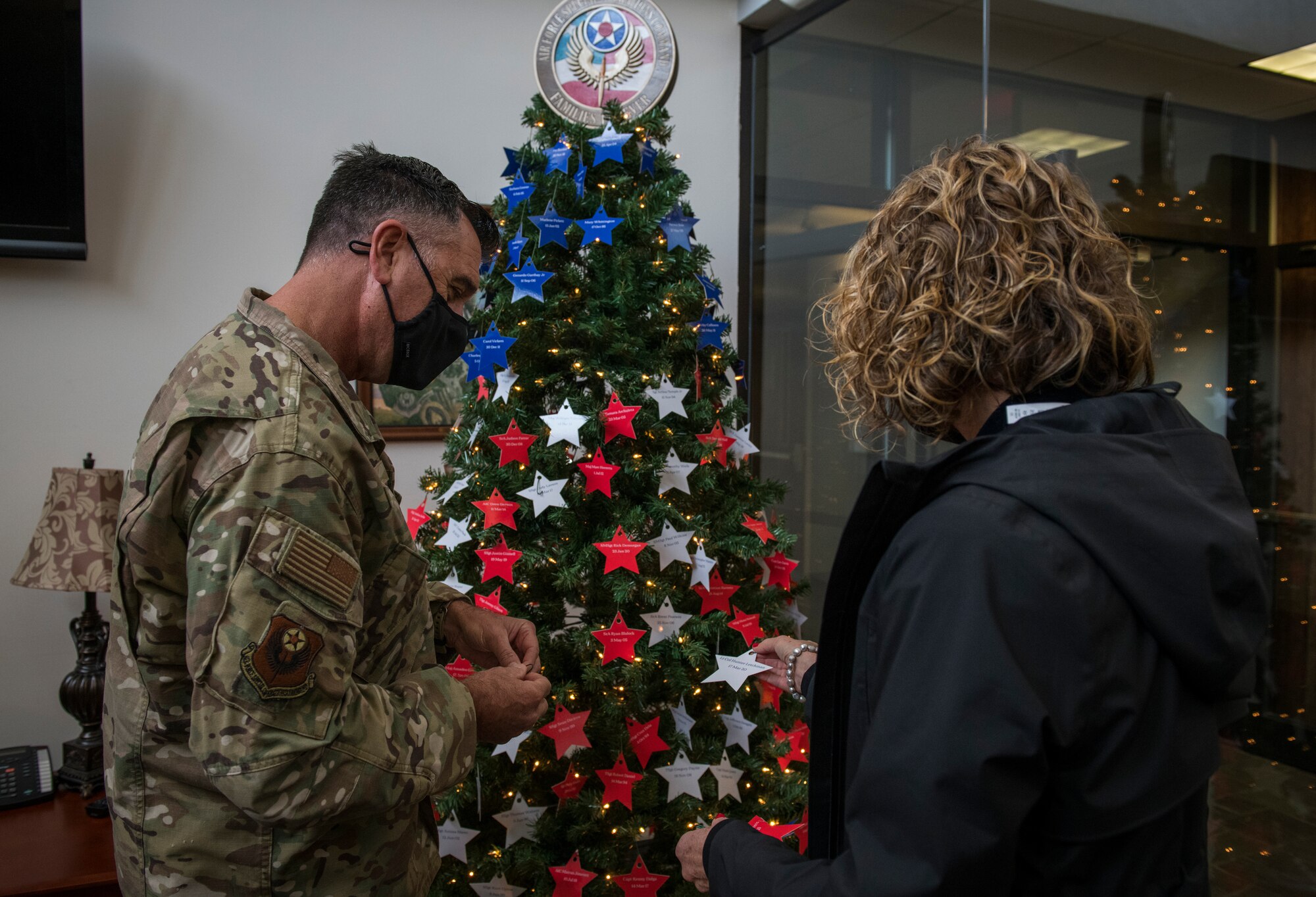 U.S. Air Force Maj. Gen. Eric Hill, deputy commander of Air Force Special Operations Command, places stars on an Honor Tree.