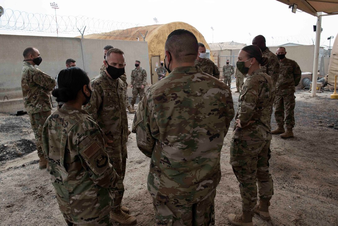 Chief Master Sgt. John Storms, 9th Air Force (Air Forces Central) command chief, talks with Airmen assigned to the 386th Air Expeditionary Wing protocol office, at Cargo City, Kuwait, Dec. 4, 2020. During the tour, Storms had lunch with Airmen assigned to the base where they asked him questions about the Air Force and upcoming changes. (U.S. Air Force photo by Staff Sgt. Kenneth Boyton)