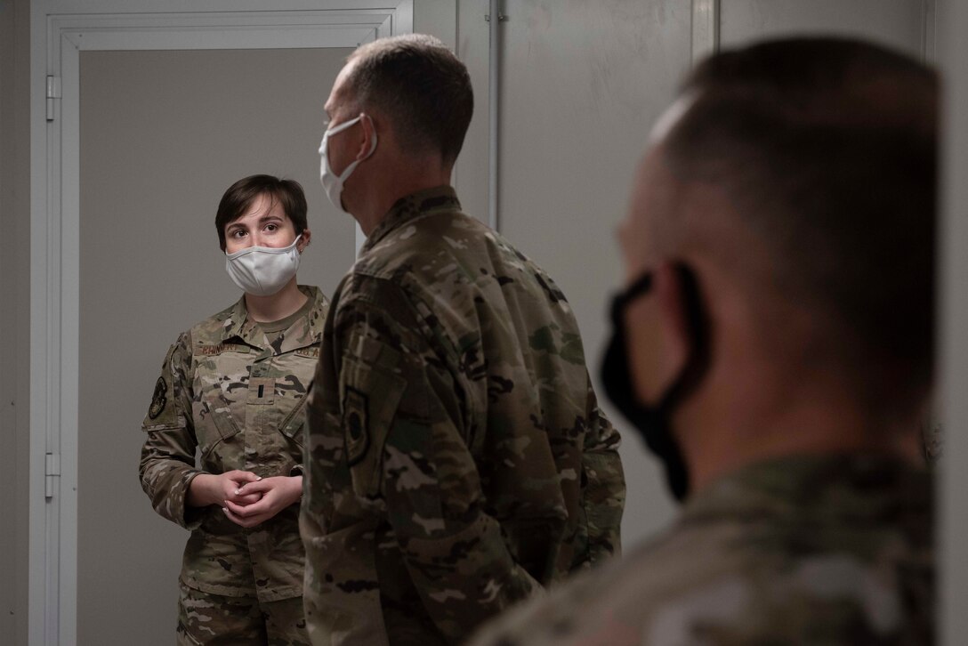 1st Lt. Allison Chinnery, 387th Expeditionary Civil Engineer Flight commander, discusses future plans for Al Mubarak, Kuwait, with Lt. Gen. Greg Guillot, 9th Air Force (Air Forces Central) commander, and Chief Master Sgt. John Storms, 9th AF (AFCENT) command chief, at Cargo City, Kuwait, Dec. 4, 2020. Guillot and Storms toured the base, met with Airmen from multiple shops and saw how they work. (U.S. Air Force photo by Staff Sgt. Kenneth Boyton)