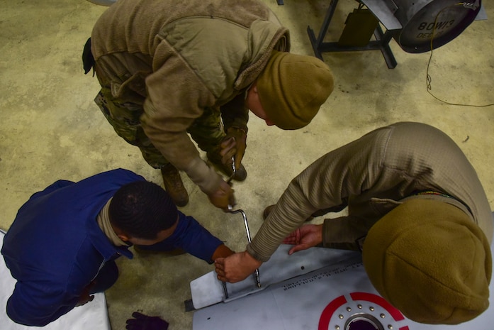 Airmen construct a fuel tank.