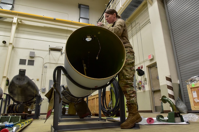 An Airman inspecting a fuel tank build.