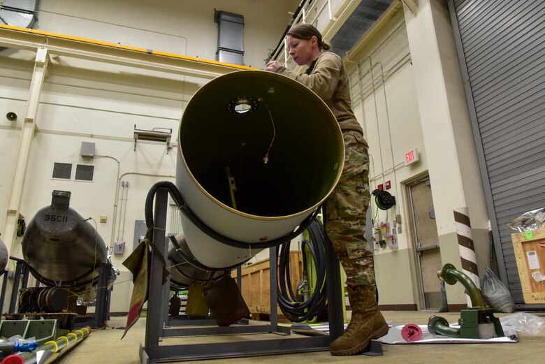 An Airman inspecting a fuel tank build.