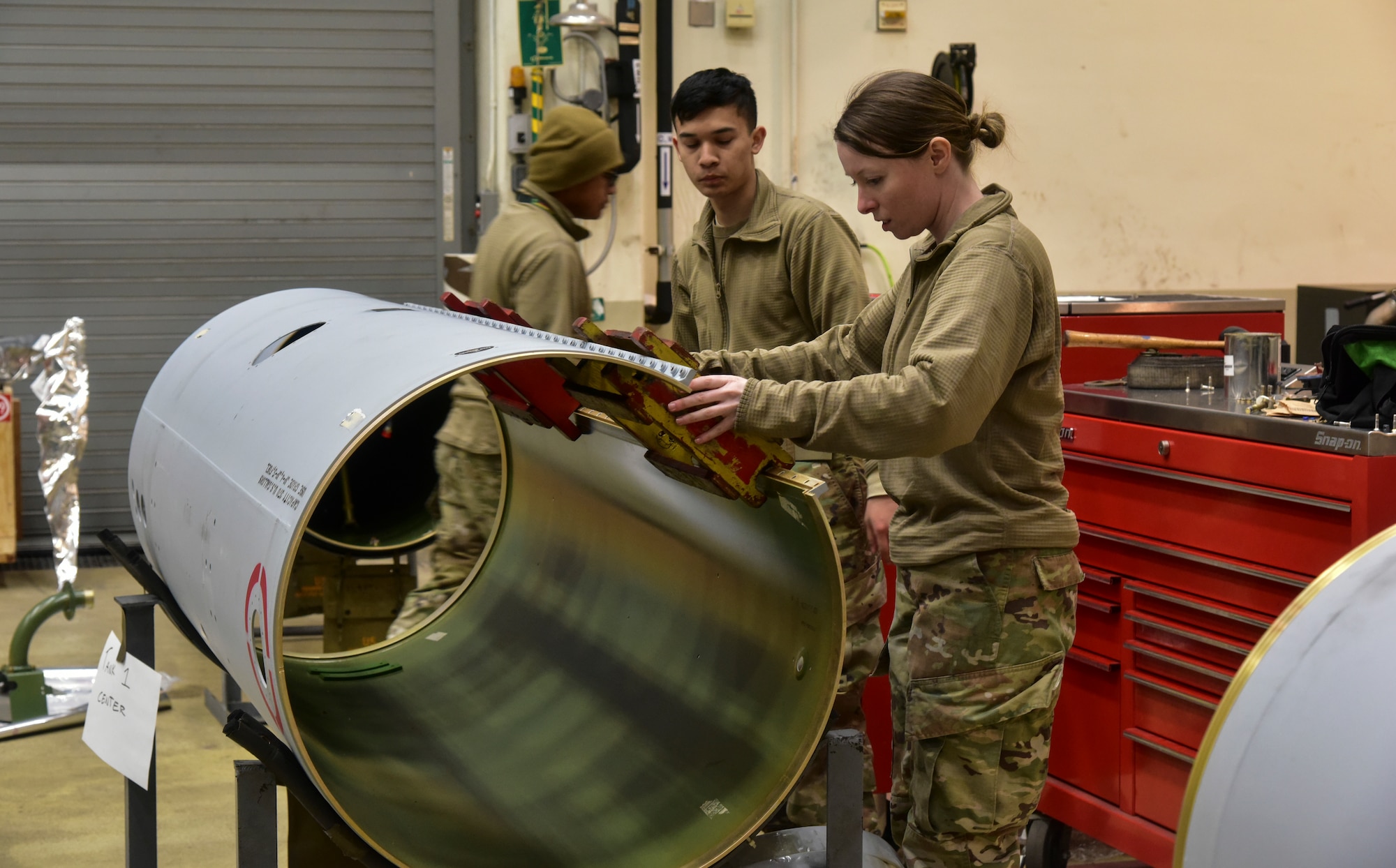 An Airman inspecting a fuel tank build.