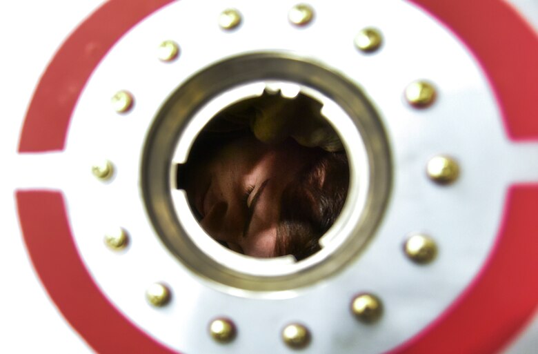 An Airman inspecting a fuel tank.