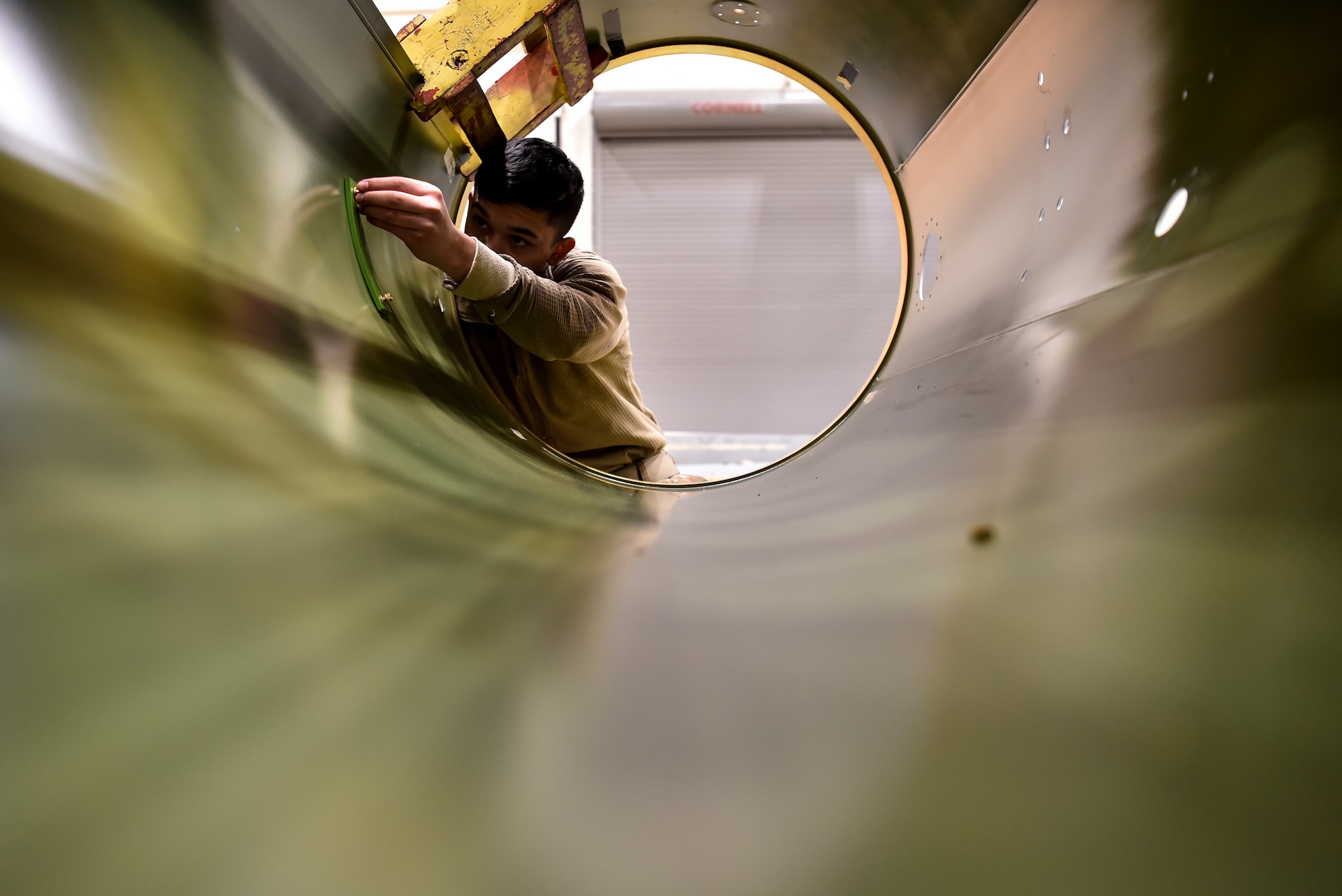 An Airman tightening a bolt.