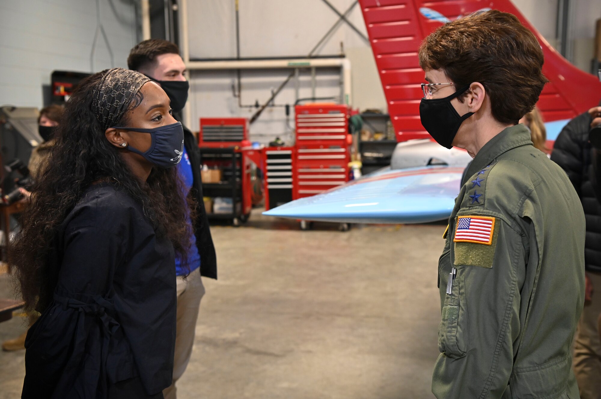 As a part of her visit to Dover Air Force Base, Delaware, Gen. Jacqueline Van Ovost, Air Mobility Command commander, speaks with Jalyn Clark, Delaware State University aviation program sophomore, at a civic outreach event at Delaware Air Park, Cheswold, Delaware, Dec. 8, 2020. Dover AFB helps foster robust relationships with AMC leaders, state legislators and local communities, promoting collaborative partnerships and efforts in support of Total Force mobility. (U.S. Air Force photo by Senior Airman Christopher Quail)