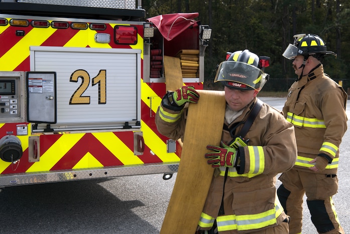 Christopher Swift, a driver operator for the 628th Civil Engineer Squadron, helps Airmen and civilian firefighters prepare for a training exercise, at Joint Base Charleston, S.C., Dec. 3, 2020. Swift and his team members at the 628th CES Fire Department support the mission by saving lives and protecting the people of Joint Base Charleston.