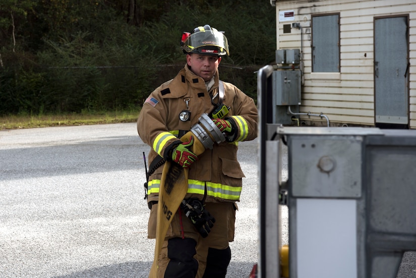 Christopher Swift, a driver operator for the 628th Civil Engineer Squadron, helps Airmen and civilian firefighters prepare for a training exercise, at Joint Base Charleston, S.C., Dec. 3, 2020. Swift and his team members at the 628th CES Fire Department support the mission by saving lives and protecting the people of Joint Base Charleston.