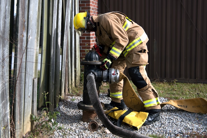 Airman 1st Class Hedrige Evra, a firefighter for the 628th Civil Engineer Squadron, connects a firehose to a fire hydrant to ensure water flows correctly through the hose, at Joint Base Charleston, S.C., Dec. 3, 2020. Swift and his team members at the 628th CES Fire Department support the mission by saving lives and protecting the people of Joint Base Charleston.