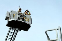 Danny Drake (left) and Chaz Cools (right), firefighters from the 628th Civil Engineer Squadron, navigate controls from the bucket and begin to position themselves for access to the roof of the training building, at Joint Base Charleston, S.C., Dec. 3, 2020. Swift and his team members at the 628th CES Fire Department support the mission by saving lives and protecting the people of Joint Base Charleston.