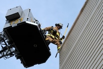 Chaz Cools, a firefighter from the 628th Civil Engineer Squadron, begins to mount himself to the top of the training building, at Joint Base Charleston, S.C., Dec. 3, 2020. Swift and his team members at the 628th CES Fire Department support the mission by saving lives and protecting the people of Joint Base Charleston.