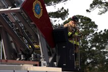 Christopher Swift, a driver operator from the 628th Civil Engineer Squadron, monitors Airmen and civilians operating during a training exercise, at Joint Base Charleston, S.C., Dec. 3, 2020. Swift and his team members at the 628th CES Fire Department support the mission by saving lives and protecting the people of Joint Base Charleston.