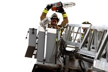 Chaz Cools, a firefighter from the 628th Civil Engineer Squadron, wields a chainsaw and poses for a picture, at Joint Base Charleston, S.C., Dec. 3, 2020. Swift and his team members at the 628th CES Fire Department support the mission by saving lives and protecting the people of Joint Base Charleston.